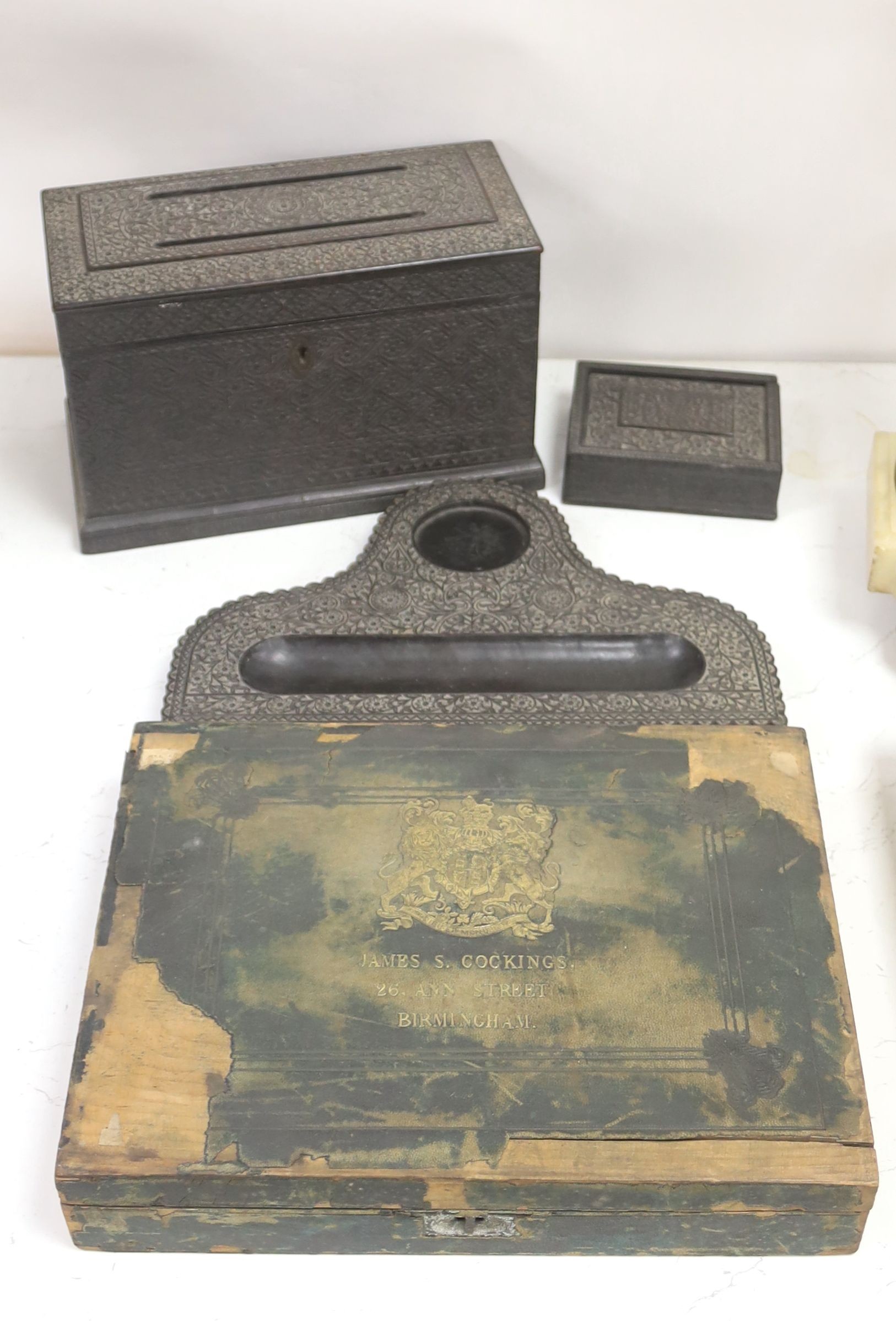 A James Cockings leather box containing a vellum patent letter with Queen Victoria Grand seal with an Indian carved box, pen stand etc
